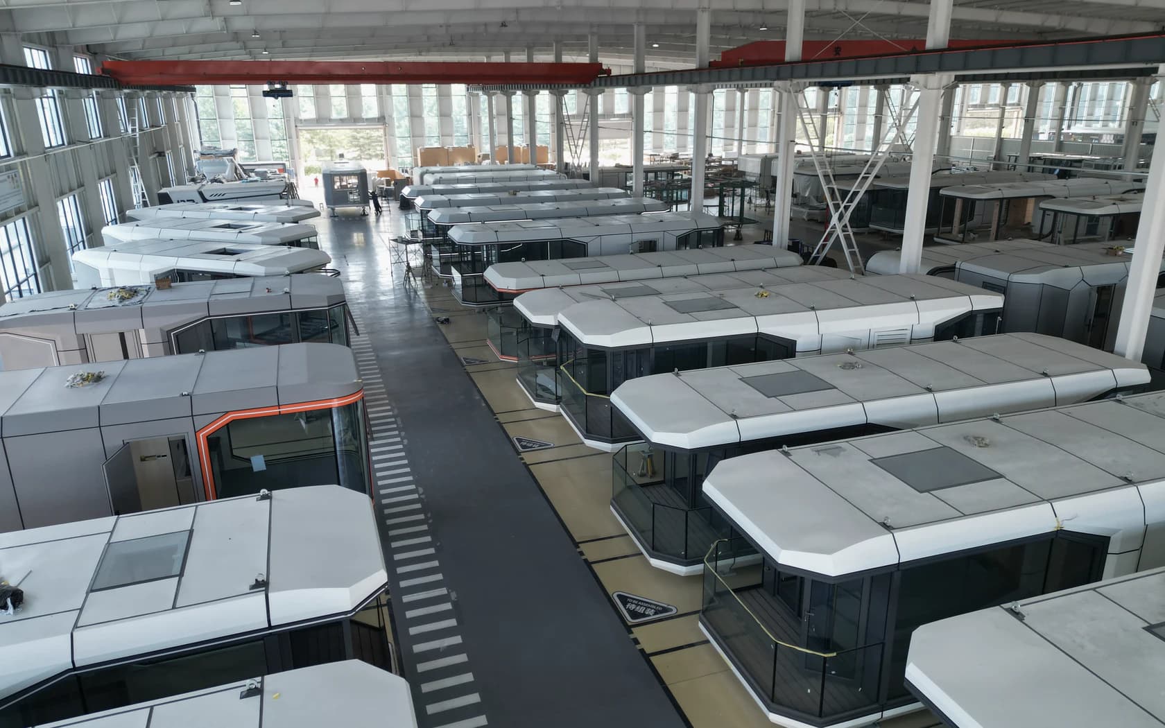 Capsule units arranged inside a production hall shown in the Domus company introduction materials