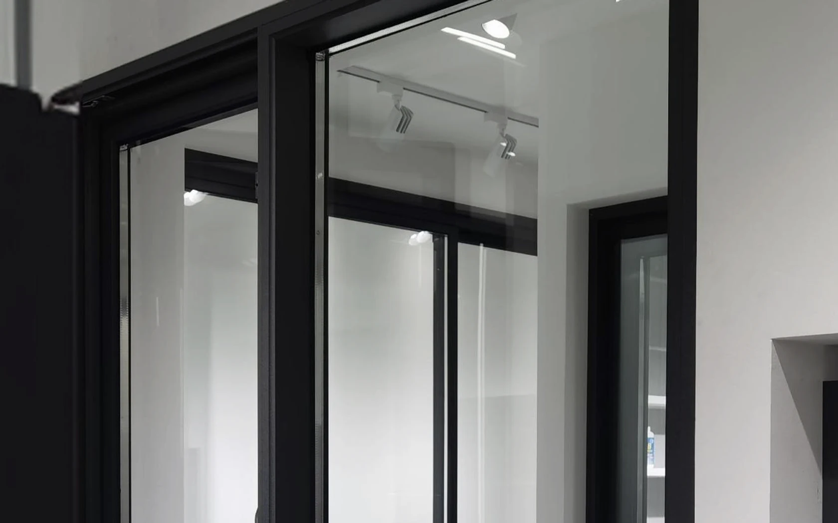 Close showroom view of assembled black aluminium glazing frames