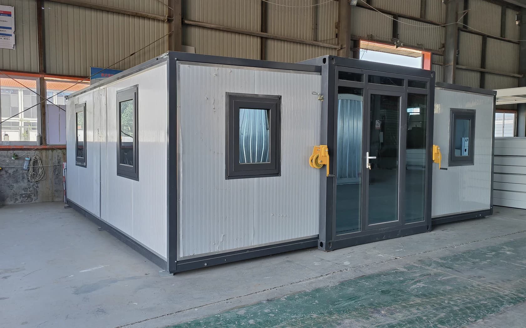 Real grey-and-white Domus expandable container deployed inside the production facility